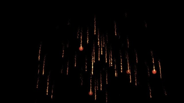 Dazzling stellar firework explosion and falling light particles on black background