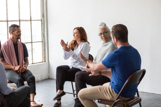 Diverse group engaged in discussion.