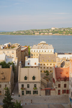 View of the historic stone buildings and rooftops in the Old Quebec district with the Saint Lawrence River in the background in Quebec City, Quebec, Canada.