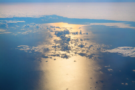 Aerial Sun Reflection On Ocean Through Clouds