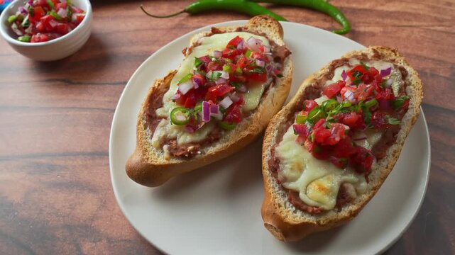 Homemade Mexican Molletes served on white plate