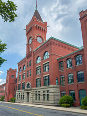 Obraz premium Historic New England Brick Factory Building with Clock Tower