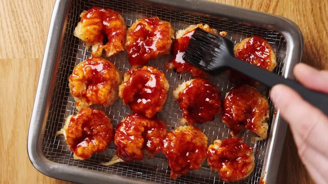 Silicone brush coats spicy shrimp with red sauce. Spicy shrimp glaze blends gochujang, chilli, garlic, soy and sesame. Serve spicy shrimp with bibimbap, noodles, rice bowls, tacos or lettuce wraps.