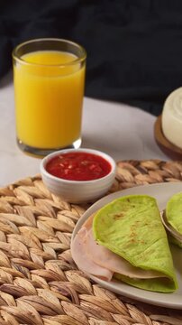 Healthy green nopal corn quesdillas served with red salsa and fresh orange juice