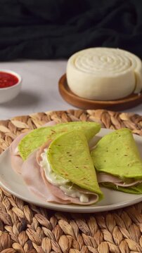 Traditional Mexican breakfast with green nopal quesadillas, red salsa and quesillo cheese