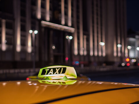 Bright Yellow Taxi Cab at Night in City