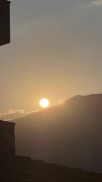 Sunset over mountains captured from balcony in quiet evening light