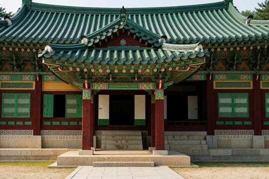 Traditional Korean Buddhist temple exterior with ornate green tiled roof, wooden pillars. Ancient architectural heritage building feature complex painted patterns. Historic religious site entrance