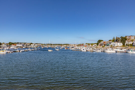 view from seaside to heritage Marina in Gloucester and old town with church, yachts and typical wooden scenic houses