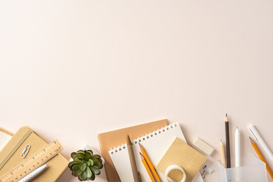 Back to school flatlay with notebooks, pencils and study supplies on a neutral desk