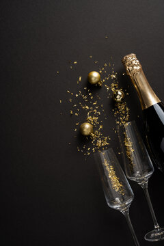 Happy New Year 2027 celebration with champagne, gold decorations and winter holiday elegance on vertical night backdrop