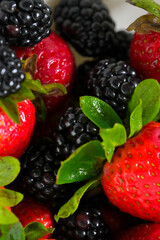 Close up of fresh ripe strawberries and blackberries background © Yevg45