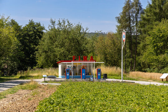 vintage Fina gas station with original gas pump in bright blue and red, featuring all original parts of a historic gas station on display in the Hessenpark open air museum