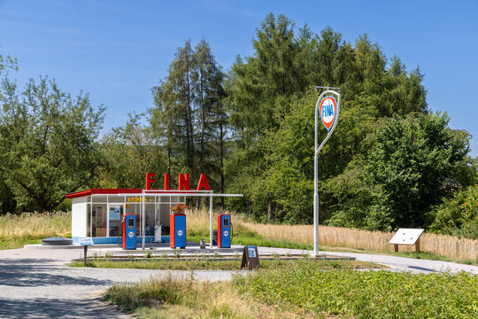 vintage Fina gas station with original gas pump in bright blue and red, featuring all original parts of a historic gas station on display in the Hessenpark open air museum