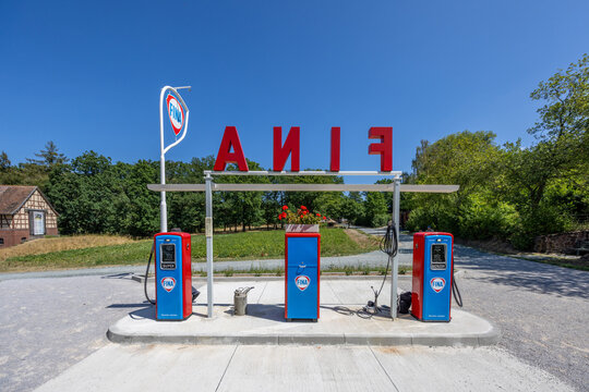vintage Fina gas station with original gas pump in bright blue and red, featuring all original parts of a historic gas station on display in the Hessenpark open air museum