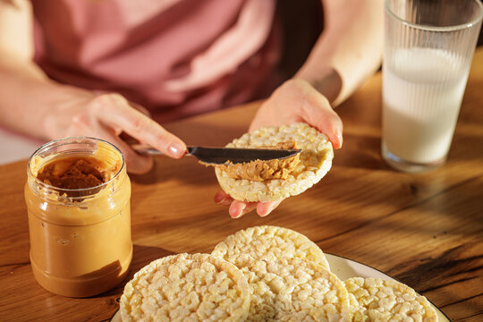 Spreading Peanut Butter On Rice Cakes For Simple Healthy Snack