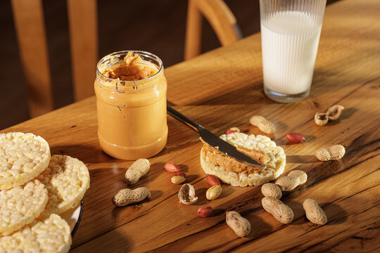 Peanut Butter Spread On Rice Cake With Glass Of Milk