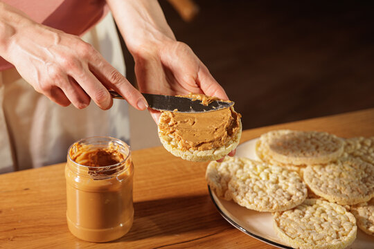 Spreading Peanut Butter On Rice Cakes For Simple Snack