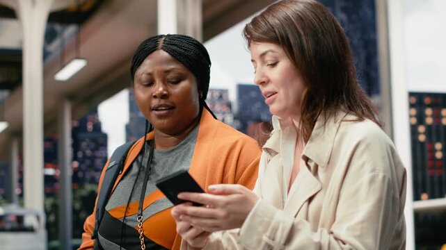 Close-up footage shows friends reviewing route details on a phone during a coach station wait, walking together through the bus terminal while using the smartphone to manage their trip itinerary.