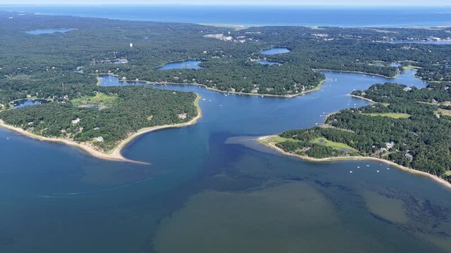 The shallow waters of Pleasant Bay are seen from a bird's eye view on a summer day. This beautiful body of water, fed by the Atlantic Ocean, is a part of Orleans and Chatham, Cape Cod, Massachusetts.