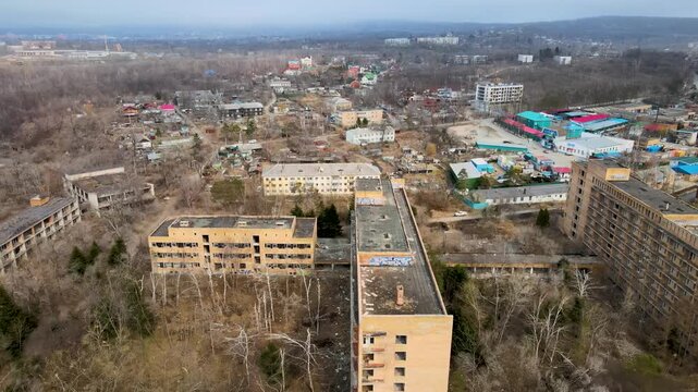 Aerial drone footage showing the abandoned buildings of the Sadgorod Mud Treatment Clinic near Vladivostok, Russia. The old Soviet-era medical complex.