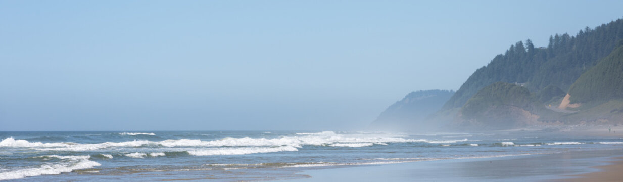 Peaceful day on the beach at Muriel O. Ponsler Memorial State Scenic Viewpoint on the Oregon coast, sandy beach with waves rolling in, sunny summer vacation road trip
