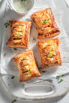 Crispy sausage in puff pastry with thyme and sesame seeds.