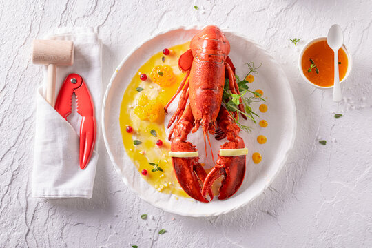 Elegant steamed lobster with butter sauce and orange.