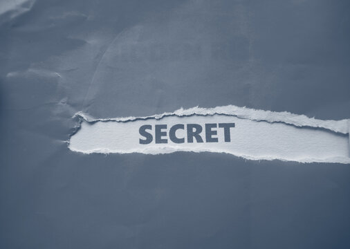 The words "SECRET" are written on the back of the torn gray paper.
