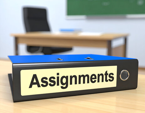 A blue three-ring binder labeled Assignments sits on a wooden desk in a classroom.