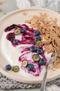 Mini cheesecake with blueberry compote and cereal on a plate