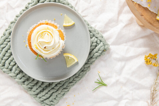 Lemon cupcake with white frosting from top view