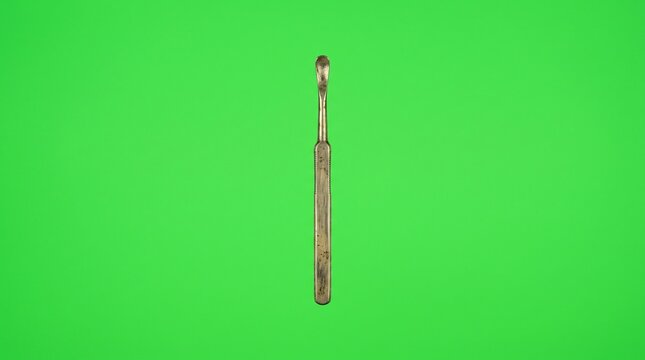 Metal ear pick cleaning wax from ear canal. Precision ear scoop tool for hygiene and ear care maintenance.