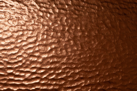 Copper brown embossed metal sheet with textured background