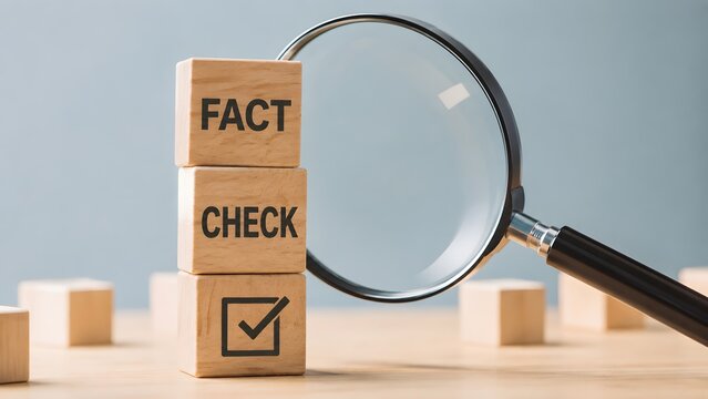 Magnifying glass focusing on fact check wooden blocks concept