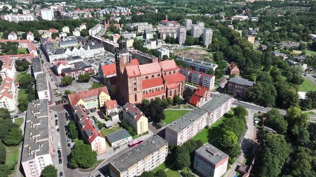 Stargard city center church apartments Poland circle pull 3. Northern Poland in 8th century. Historical stronghold, defensive walls, gates towers. WW II POW camp controlled by Germany. Brick church.