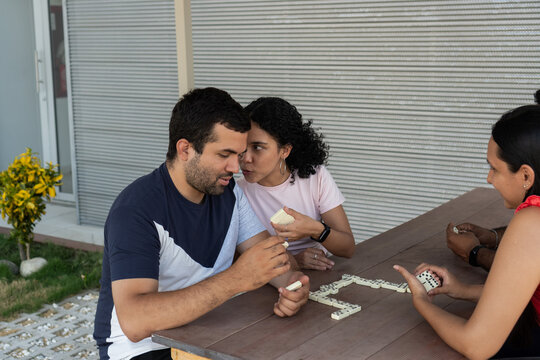 Friends playing dominoes sharing strategy during game
