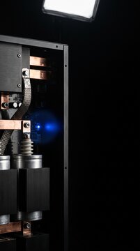 High-performance server hardware with copper heat-sink and green LED indicator in dark data center environment with negative space.