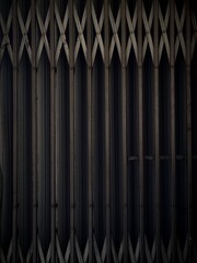 Vintage metal folding gate texture background with dark dim lighting © ray0Zz