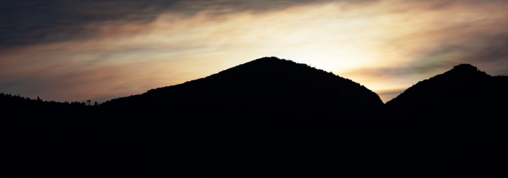 Full moon that's just vanished behind the Huachuca Mountains
