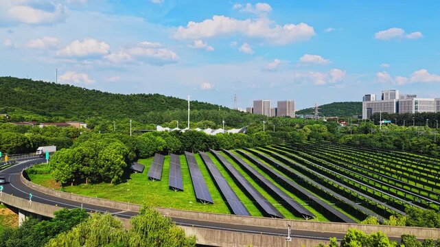Drone flying forward above solar panels in an urban green belt
