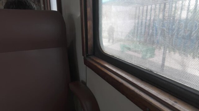 Wooden window frame and empty seat inside the University Train railcar in La Plata, Buenos Aires, Argentina. D-Log M, 10-bit color, flat log profile.