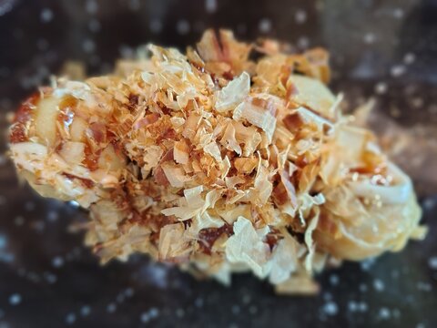 Delicious Takoyaki with katsuobushi Topping on a Savory Dish.