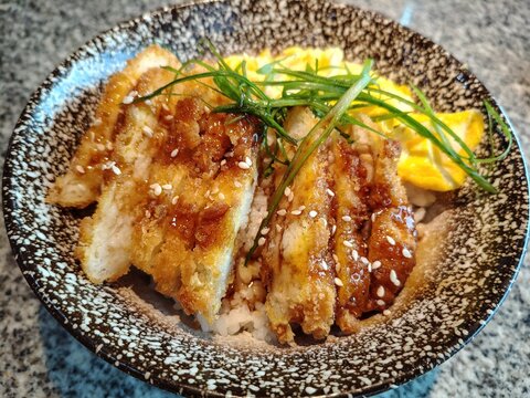 Delicious Japanese Teriyaki Chicken Rice Bowl with Scrambled Eggs and Green Onions.