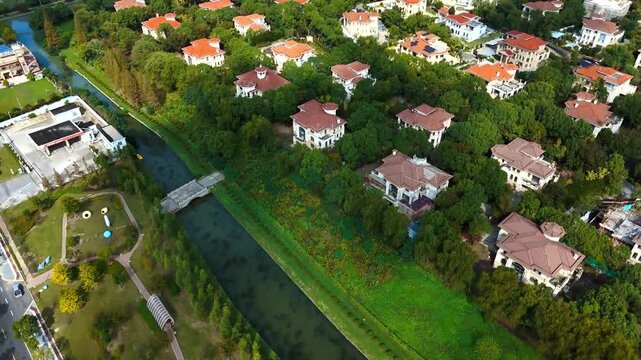 Forward Drone Flight Over Canal and Residential Villas Near Sheshan