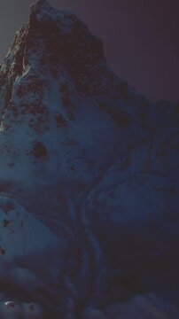The towering mountain rises against a serene sky, bathed in twilight hues. Snow blankets the rugged terrain, creating a tranquil and enchanting winter scene that invites exploration.