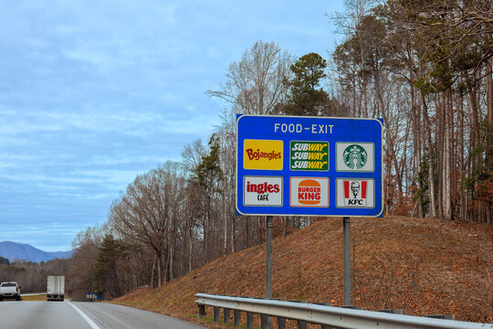 02 December 2025 Asheville, North Carolina Travelers can see different food options like Bojangles, Subway, Starbucks on American highway sign