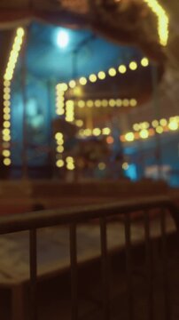 Bright lights twinkle against a backdrop of joy and laughter. The merry go round spins gently, inviting children and families to join in the festive atmosphere of the night.