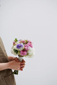 A woman holding a wedding bouquet