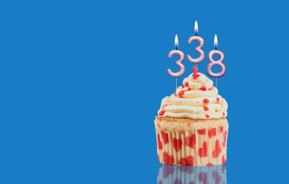 Birthday Or Anniversary Cupcake With Lit Candles; Candles Forming The Number 338